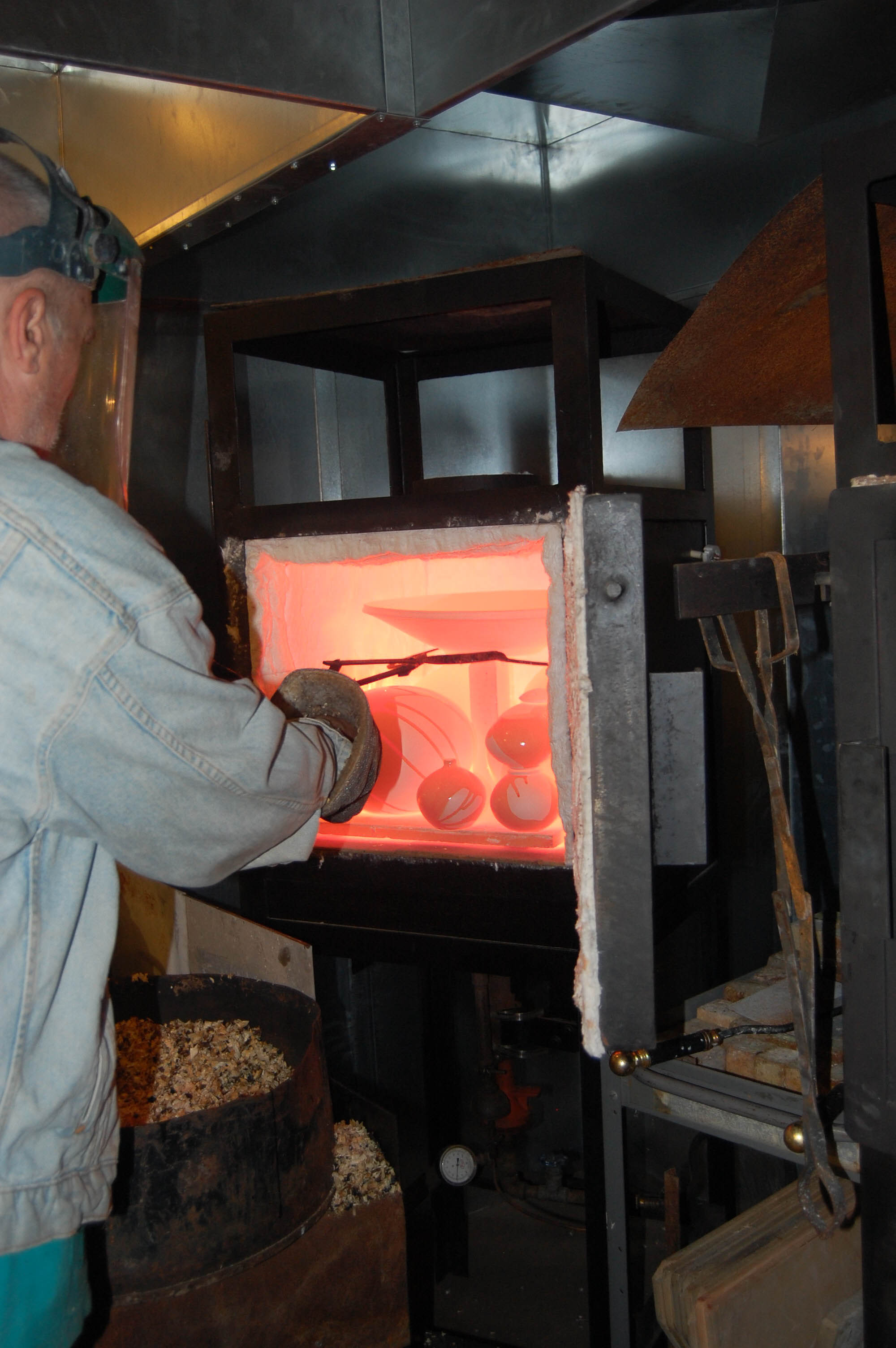 Andrew Berends checking his kiln